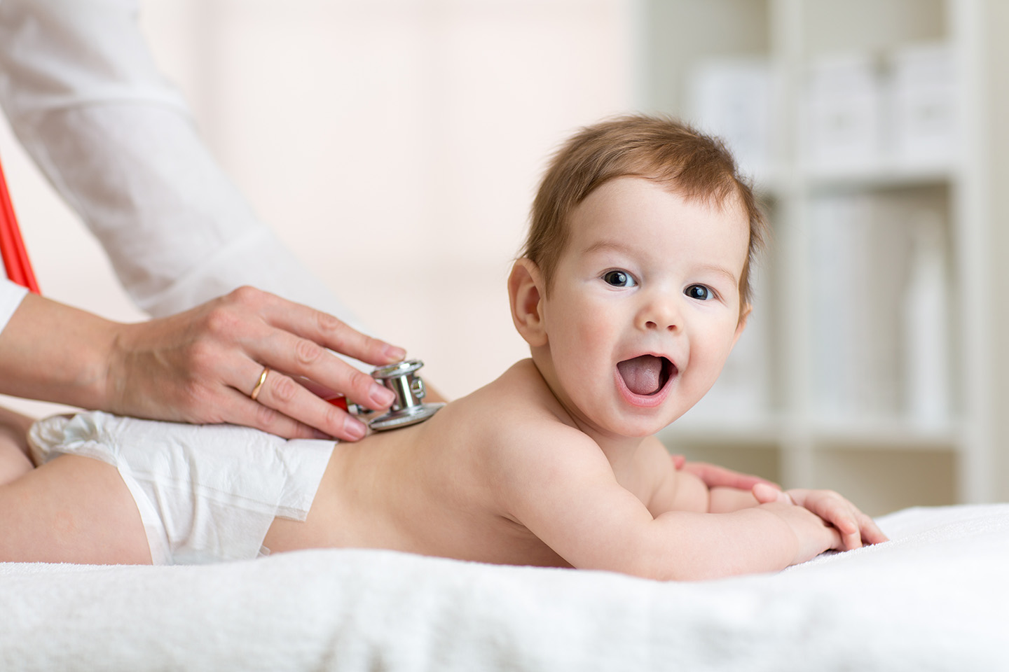 Infant getting examined by a doctor